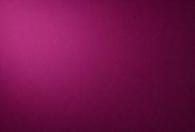 The primary subject of the image is a large, purple wall. The setting is a room with a pink background, which creates a contrasting and vibrant atmosphere. The visual style is a close-up of the wall, showcasing its color and texture. The dominant colors are purple and pink, giving the image a warm and inviting mood.