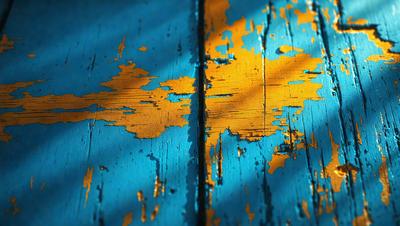 The primary subject of the image is a blue wooden wall with yellow paint peeling off it. The setting is a room with a blue wall and a yellow peeling paint area. The visual style is a photo of the wall, showcasing the peeling paint and the contrast between the blue and yellow colors. The colors and mood of the image are predominantly blue and yellow, with a slightly aged and worn appearance due to the peeling paint.