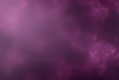 The primary subject of the image is a purple sky with a cloudy background. The setting appears to be a nighttime scene, with the sky being the main focus of the image. The visual style is a combination of a photo and a digital art, creating a unique and artistic representation of the purple sky. The colors and mood of the image are predominantly purple, creating a serene and calming atmosphere.