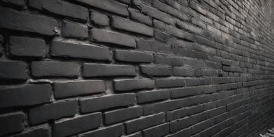 The primary subject of the image is a brick wall with a black color. The setting is a dark room, and the visual style appears to be a photo. The dominant colors are black and grey, creating a moody atmosphere.