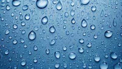The primary subject of the image is a close-up of a raindrop-filled sky. The setting is a blue background, which creates a serene and calming atmosphere. The visual style is a photo, capturing the beauty of the raindrops and the sky. The colors are predominantly blue, with the raindrops adding a touch of white and gray. The overall mood of the image is peaceful and tranquil.