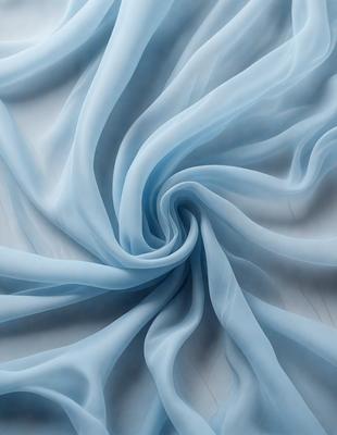 The primary subject of the image is a blue sheet of fabric, which is the main object, scene, or focus of the image. The setting or background is a white surface, which provides a clean and contrasting backdrop for the blue fabric. The visual style of the image is a close-up of the blue fabric, showcasing its texture and pattern. The colors and mood of the image are predominantly blue, creating a calm and serene atmosphere.