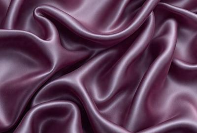 The primary subject of the image is a purple fabric, which is the main object, scene, or focus of the image. The setting/background consists of a purple surface, which is the visible environment, backdrop, or surface. The visual style of the image is a photo, as it is a real-life photograph of the purple fabric. The colors and mood of the image are predominantly purple, creating a calm and soothing atmosphere.