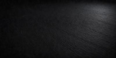 The primary subject of the image is a black leather surface. The setting is a dark room, and the visual style is a close-up of the leather surface. The colors and mood of the image are predominantly dark and moody, with the black leather being the main focus.
