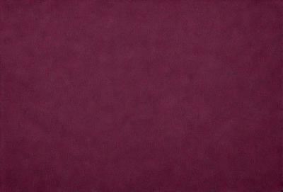 The primary subject of the image is a close-up of a maroon-colored surface. The setting is a dark room, and the visual style appears to be a photo. The dominant colors in the image are maroon and purple, creating a warm and cozy atmosphere.