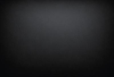 The image is a black and white photo of a dark background.