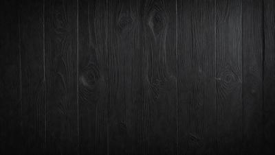 The primary subject of the image is a wooden floor with a black color. The setting is a room with a black background. The visual style is a photo of a wooden floor. The colors and mood are dark and moody.