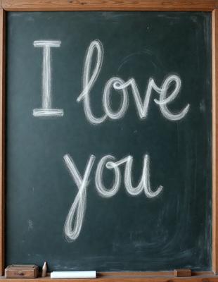 The primary subject of the image is a chalkboard with the words "I love you" written on it. The setting is a room with a wooden surface, and the visual style is a handwritten message. The colors and mood of the image are warm and affectionate, as the message expresses love and affection.