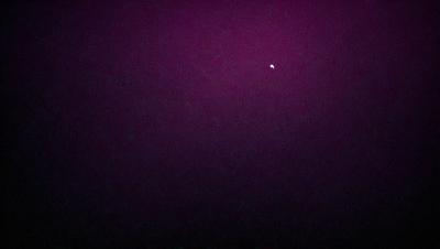 The image features a dark, purple sky with a single star visible in the distance. The star is located towards the upper right corner of the image. The overall atmosphere of the scene is serene and peaceful, with the star being the only point of interest in the vast, dark sky.
