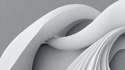 The primary subject of the image is a white, curved, and twisted piece of paper. The paper is the main object, and it is the focal point of the image. The setting is a gray background, which provides a contrasting and neutral environment for the paper. The visual style of the image is a close-up of the paper, showcasing its intricate and artistic design. The colors and mood of the image are predominantly white, giving it a clean and minimalist appearance.