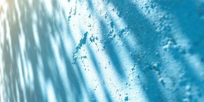 The primary subject of the image is a wall with a blue color. The setting is a room with a blue wall, and the visual style is a photo. The dominant colors are blue and white, creating a calm and serene atmosphere.