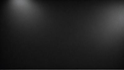 The primary subject of the image is a black background. The setting is a dark room, and the visual style is a black and white photo. The colors and mood of the image are predominantly dark and moody.