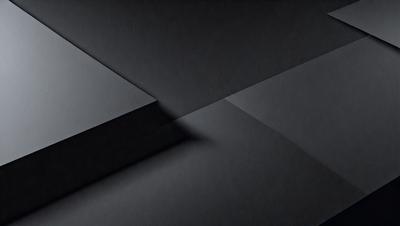 The primary subject of the image is a black square, which is the main object, scene, or focus of the image. The setting or background is a black surface, which creates a contrast with the black square. The visual style of the image is a black and white photo, which adds a sense of depth and contrast to the composition. The colors and mood of the image are predominantly black, which gives it a moody and dramatic atmosphere.