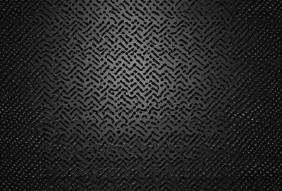 The primary subject of the image is a close-up of a black metal surface with a pattern of interlocking shapes. The setting is a dark room, and the visual style appears to be a combination of a photo and a digital art or illustration. The dominant colors are black and grey, creating a moody atmosphere.