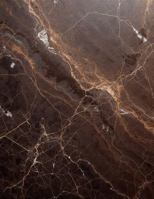 The primary subject of the image is a marble countertop with a brown and white pattern. The setting is a kitchen, and the visual style is a close-up of the marble countertop. The colors and mood of the image are warm and natural, with the brown and white marble creating a sense of elegance and sophistication.