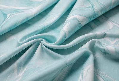 The primary subject of the image is a blue fabric, which is the main object, scene, or focus of the image. The setting or background is a blue sheet, and the visual style is a photo. The dominant colors and overall atmosphere are blue and calm.