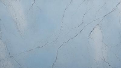 The primary subject of the image is a blue wall with a white marble texture. The setting is a room with a blue background. The visual style is a close-up of the marble wall, showcasing its texture and details. The colors and mood of the image are predominantly blue and white, creating a calm and serene atmosphere.