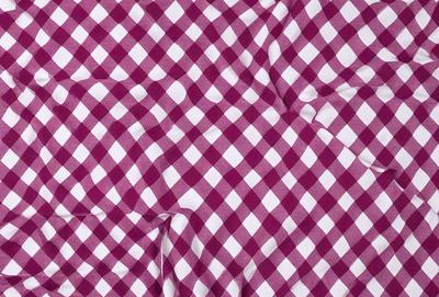 The primary subject of the image is a checkered pattern, which is displayed on a purple and white background. The visual style of the image is a close-up of the checkered pattern, showcasing its intricate details. The colors and mood of the image are predominantly purple and white, creating a clean and elegant appearance.