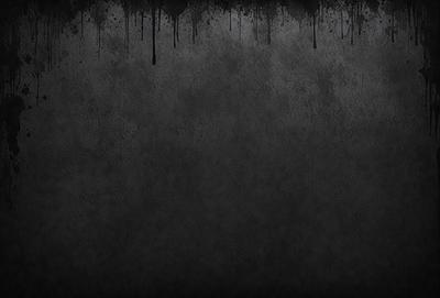 The primary subject of the image is a black and white photo of a wall. The setting is a concrete wall with a few black spots on it. The visual style is a black and white photo, which gives it a classic and timeless appearance. The colors and mood of the image are predominantly dark and moody, with the black and white color scheme adding to the overall atmosphere.