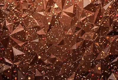 The primary subject of the image is a close-up of a chocolate cake with sprinkles on it. The cake is the main focus of the image, and it is presented in a visually appealing manner. The setting is a kitchen, with the cake placed on a dining table. The visual style of the image is a close-up, which emphasizes the details of the cake and the sprinkles. The colors and mood of the image are predominantly warm and inviting, with
