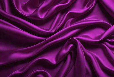 The primary subject of the image is a purple fabric, which is the main object, scene, or focus of the image. The setting or background is a purple sheet, and the visual style is a photo. The colors and mood of the image are predominantly purple, creating a calm and soothing atmosphere.