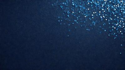 The primary subject of the image is a blue background with a pattern of glittering blue stars. The setting is a dark blue sky, and the visual style is a digital art or illustration. The colors and mood of the image are predominantly dark blue and serene, with the glittering blue stars adding a touch of brightness and interest to the overall atmosphere.