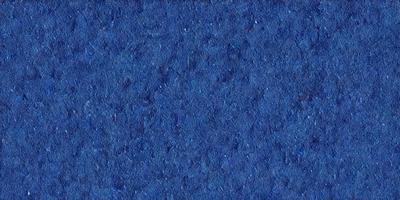 The primary subject of the image is a blue background with a pattern of white dots. The setting is a dark blue surface, which creates a contrast with the white dots. The visual style is a close-up of the blue background, showcasing the intricate pattern of the white dots. The colors and mood of the image are predominantly dark blue and white, giving it a calm and serene atmosphere.