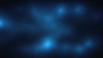The primary subject of the image is a blue background with a pattern of white lines. The setting appears to be a dark, possibly nighttime, environment. The visual style of the image is a combination of a photo and a digital art, as it features a blue background with white lines, which gives it a unique and artistic appearance. The colors and mood of the image are predominantly dark and moody, with the blue background and white lines creating a sense of depth and contrast.