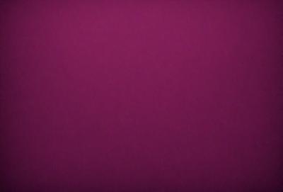 The primary subject of the image is a purple background. The setting is a dark, purple room. The visual style is a close-up of the purple wall. The colors and mood are predominantly purple, creating a calm and serene atmosphere.