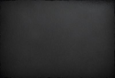 The primary subject of the image is a black background. The setting is a dark room, and the visual style is a black and white photo. The colors and mood of the image are predominantly dark and moody.