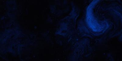 The primary subject of the image is a blue background with a black and white pattern. The setting is a space-like environment, possibly a galaxy or a deep-space scene. The visual style appears to be a digital art or illustration, with a focus on the contrasting colors of blue and black and white. The overall atmosphere of the image is dark and mysterious, with the black and white pattern adding to the depth and intrigue of the scene.