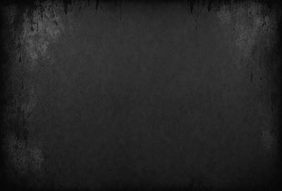 The primary subject of the image is a black and white photo of a wall. The setting is a room with a wall that appears to be made of concrete. The visual style is a black and white photo, which gives the image a classic and timeless appearance. The colors and mood of the image are predominantly dark and moody, with the black and white tones adding to the overall atmosphere.