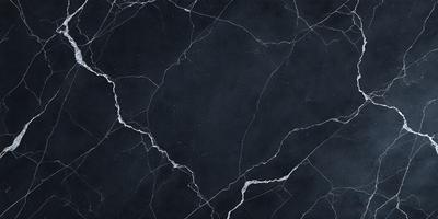 The primary subject of the image is a black marble countertop. The setting is a kitchen, with the countertop being the main focus of the scene. The visual style is a close-up of the marble countertop, showcasing its texture and details. The colors and mood of the image are dark and moody, with the black marble countertop being the dominant color.