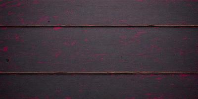 The primary subject of the image is a wooden wall with a pinkish-purple color. The setting is a room with a wooden surface, and the visual style appears to be a photo. The dominant colors and overall atmosphere are a mix of pink and purple, creating a unique and eye-catching appearance.