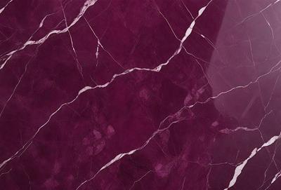 The primary subject of the image is a marble wall with a purple hue. The setting is a room with a purple marble wall, which serves as the background. The visual style is a close-up of the marble wall, showcasing its texture and color. The colors and mood of the image are predominantly purple, creating a calm and elegant atmosphere.