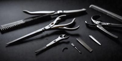 The primary subject of the image is a pair of scissors. The scissors are placed on a black surface, which serves as the setting or background. The visual style of the image is a photo, capturing the details of the scissors and their surroundings. The colors in the image are predominantly black, giving the scene a sleek and modern appearance.