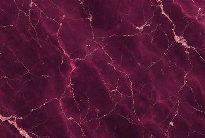 The primary subject of the image is a close-up of a marbled surface, which appears to be a wall or a piece of artwork. The setting is a dark room, and the visual style is a close-up of the marbled surface. The colors and mood of the image are predominantly dark and moody, with the marbled surface being the main focus.