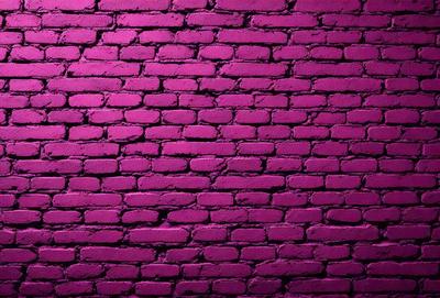 The primary subject of the image is a brick wall with a purple hue. The setting is a brick wall, and the visual style is a photo. The dominant colors are purple and pink, creating a moody and dramatic atmosphere.