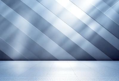 The primary subject of the image is a large, shiny, metallic wall. The setting is a room with a white floor, and the visual style is a photo. The colors and mood of the image are predominantly silver and white, creating a clean and modern atmosphere.