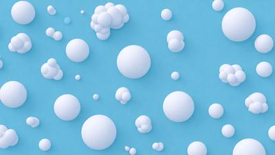 The primary subject of the image is a collection of white bubbles floating in a blue background. The setting is a blue surface, which could be a wall or a background. The visual style is digital art, as the bubbles are created using a computer program. The colors are predominantly white and blue, giving the image a calm and soothing atmosphere.