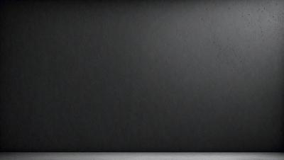 The primary subject of the image is a black wall with a gray background. The setting is a plain, empty room with no other objects or people visible. The visual style is a black and white photo, which gives the image a classic and timeless appearance. The dominant colors are black and gray, creating a moody and dramatic atmosphere.