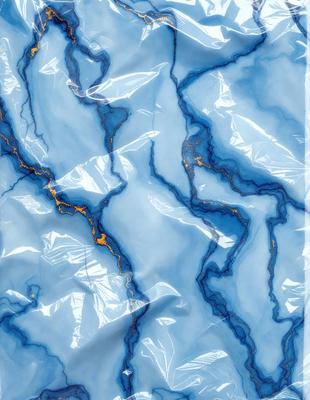 The primary subject of the image is a blue and gold patterned plastic bag. The setting is a close-up of the bag, showcasing its unique design. The visual style is a close-up of the bag, which gives a sense of texture and pattern. The colors and mood of the image are predominantly blue and gold, creating a vibrant and eye-catching appearance.