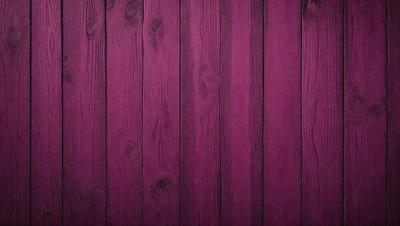 The primary subject of the image is a wooden wall with a purple color. The setting is a room with a wooden surface, and the visual style is a close-up of the wooden wall. The dominant colors are purple and brown, creating a warm and cozy atmosphere.