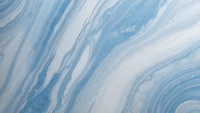 The primary subject of the image is a blue and white marbled wall. The setting is a room with a blue and white marbled wall as the main focus. The visual style is a photo of the marbled wall. The dominant colors are blue and white, creating a calm and soothing atmosphere.