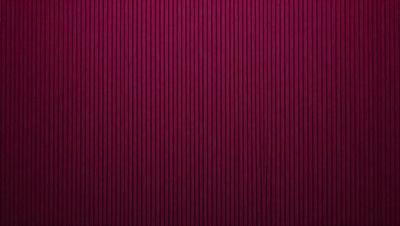 The primary subject of the image is a red wall with a patterned design. The setting is a room with a red wall, and the visual style appears to be a photo. The dominant colors in the image are red and purple, creating a bold and striking atmosphere.