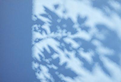 The primary subject of the image is a cloudy sky with a pattern of snowflakes. The setting is a blue sky, and the visual style is a photo. The dominant colors are blue and white, creating a calm and serene atmosphere.