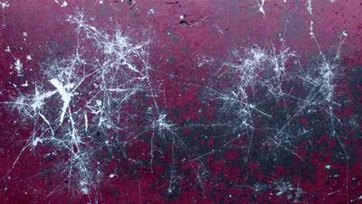 The primary subject of the image is a close-up of a red surface with white streaks, possibly a marbled or textured material. The setting appears to be a wall or a similar surface. The visual style of the image is a close-up, which emphasizes the details of the red and white pattern. The colors and mood of the image are predominantly red and white, creating a striking contrast and a visually engaging scene.