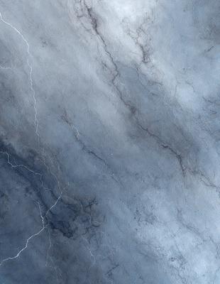 The primary subject of the image is a marble surface with a blue tint. The setting is a stone wall, and the visual style is a close-up of the marble surface. The colors and mood of the image are predominantly blue and gray, creating a calm and serene atmosphere.