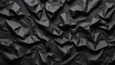 The primary subject of the image is a black wall with a pattern of folded paper or a black and white paper texture. The setting is a dark room, and the visual style appears to be a close-up of the paper pattern. The colors and mood of the image are predominantly dark and moody, with the black wall and paper pattern creating a dramatic and intriguing atmosphere.