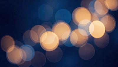 The primary subject of the image is a blue background with a pattern of white circles. The setting appears to be a nighttime scene, possibly a cityscape or a dark room with lights. The visual style of the image is a combination of a photo and digital art, creating a unique and artistic representation of the circles. The dominant colors are blue and white, with the white circles standing out against the blue background. The overall atmosphere of the image is one of mystery and intrigue, as the viewer is drawn into the pattern of the